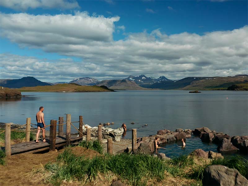 4 people enjoy Hvammsvik hot springs in Iceland