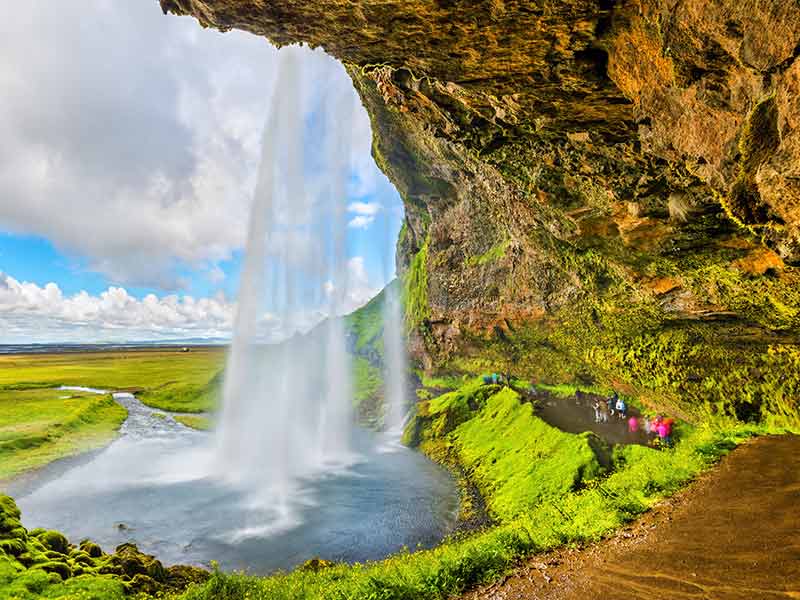 At the back of Seljalandsfoss waterfall in Iceland